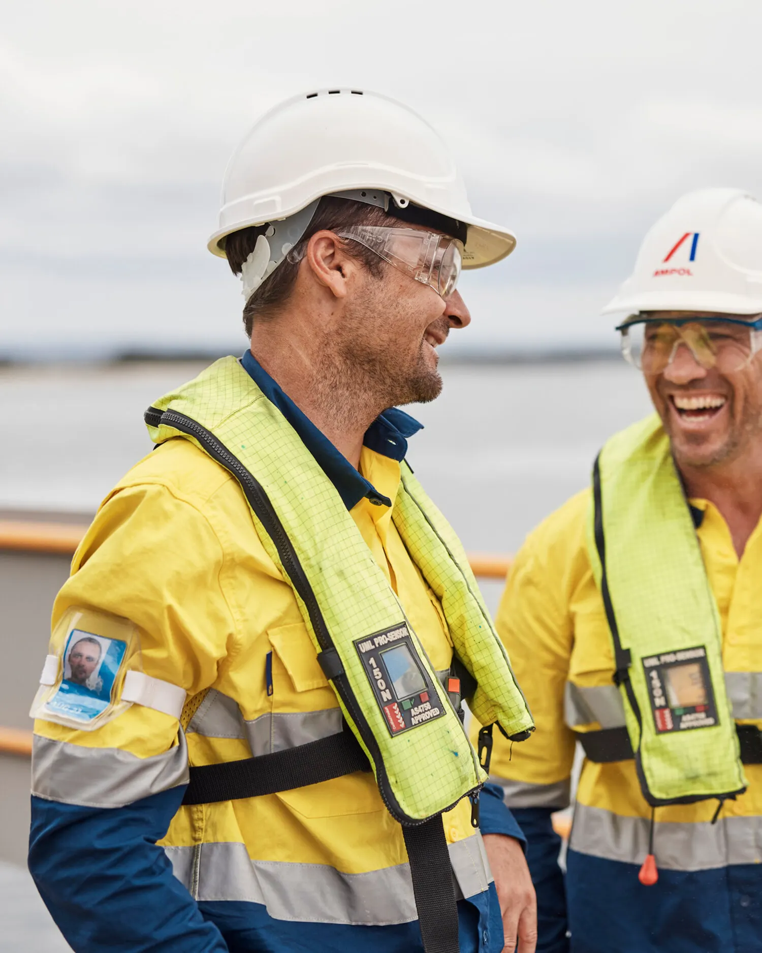 Two workers in hi-vis sharing a laugh on site